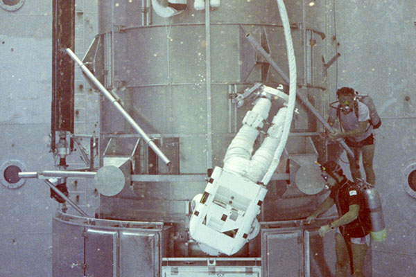 Kathy Sullivan  practices EVA tasks on the Hubble mockup.